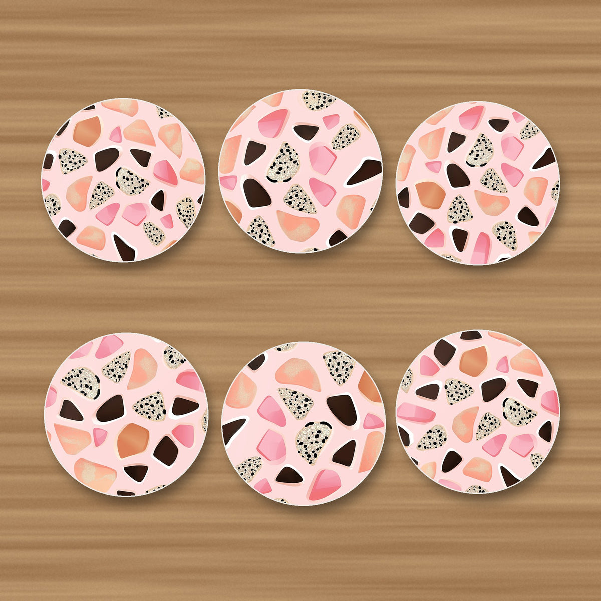 Blush Pink Terrazzo round ceramic coasters, set of 6, glossy finish, on an oak coffee table