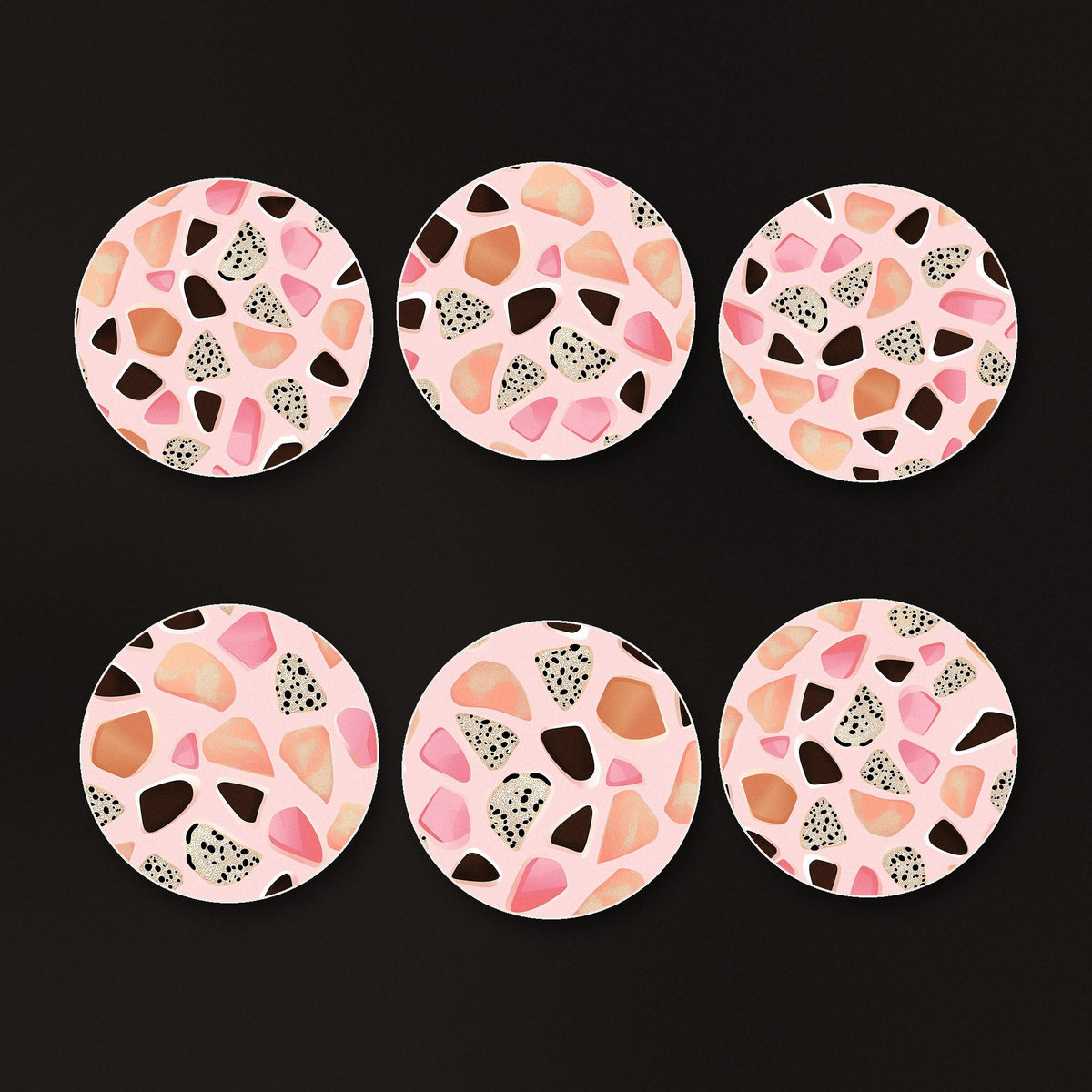 Blush Pink Terrazzo round ceramic coasters, matte finish, on a dark bar counter