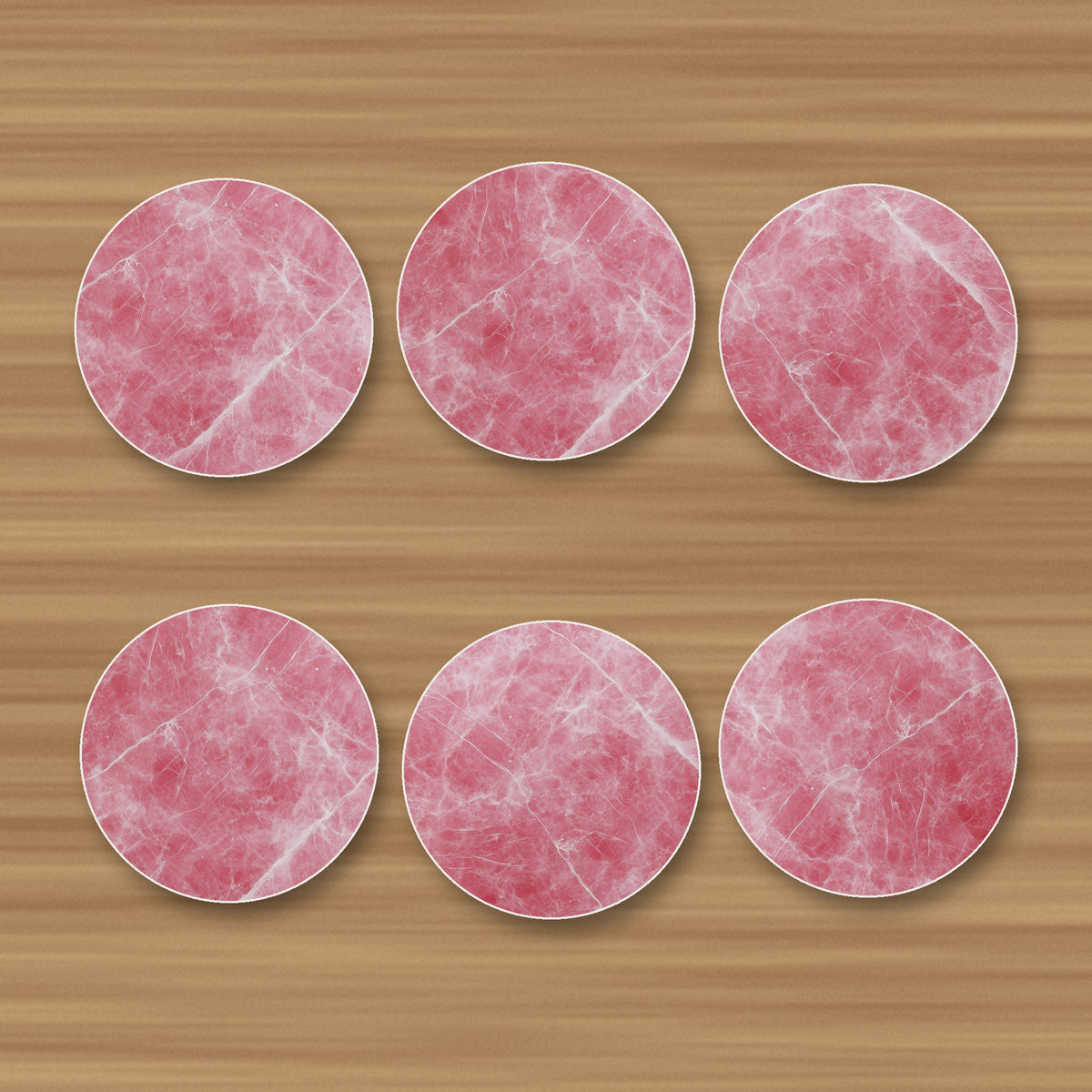 Rose Quartz Pink Marble round ceramic coasters, set of 6, glossy finish, on an oak coffee table