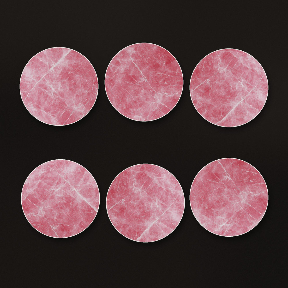 Rose Quartz Pink Marble round ceramic coasters, matte finish, on a dark bar counter