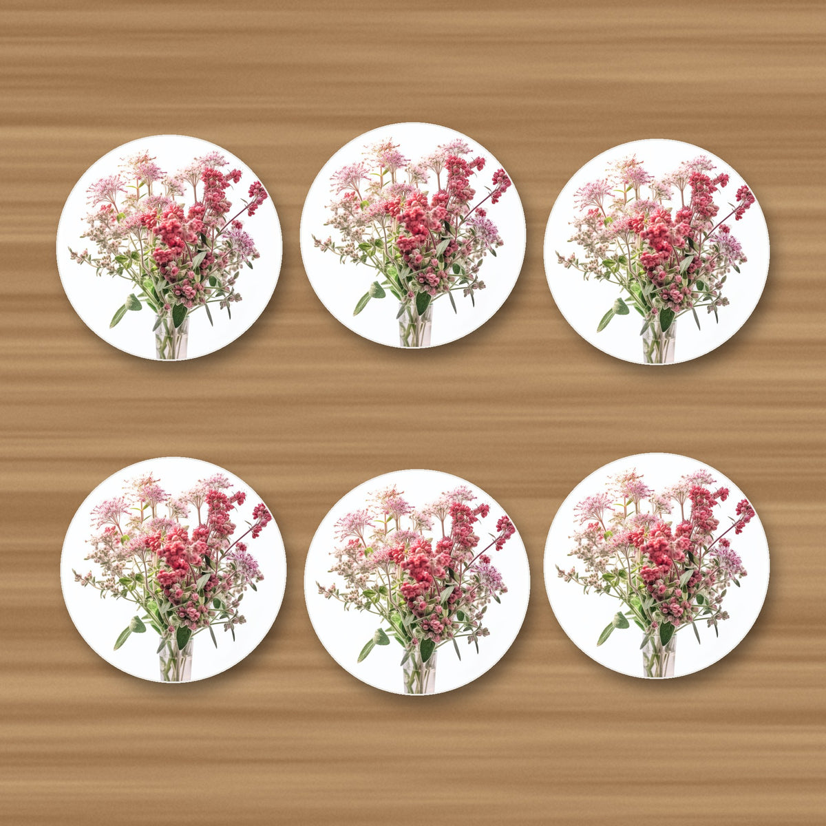 Pink Wildflower Bouquet round ceramic coasters, set of 6, glossy finish, on an oak coffee table