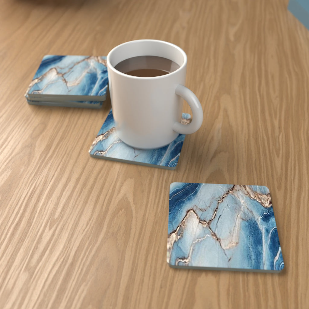 Cyan, Blue & Gold Marble square glass coasters on an oak coffee table with a mug – lifestyle mockup 1