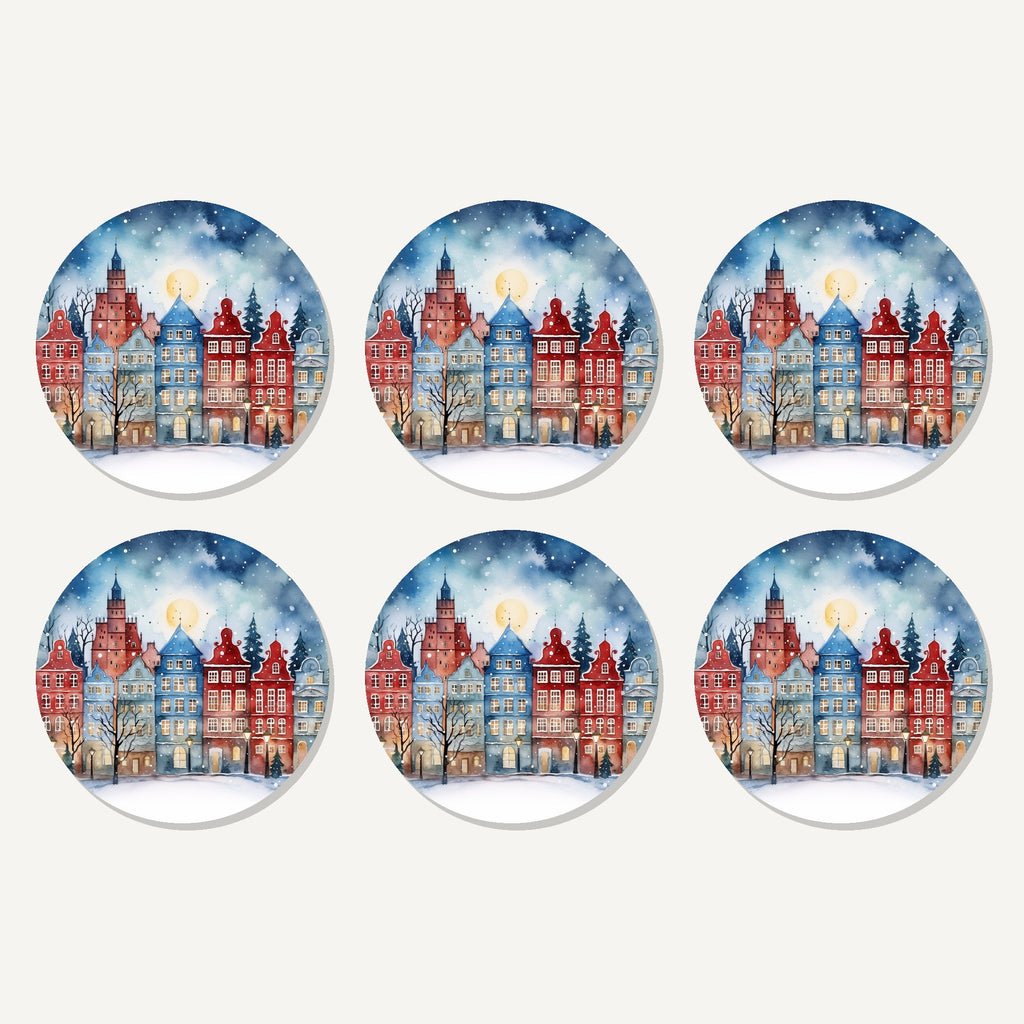 Flat lay of the watercolour christmas town artwork on six round coasters