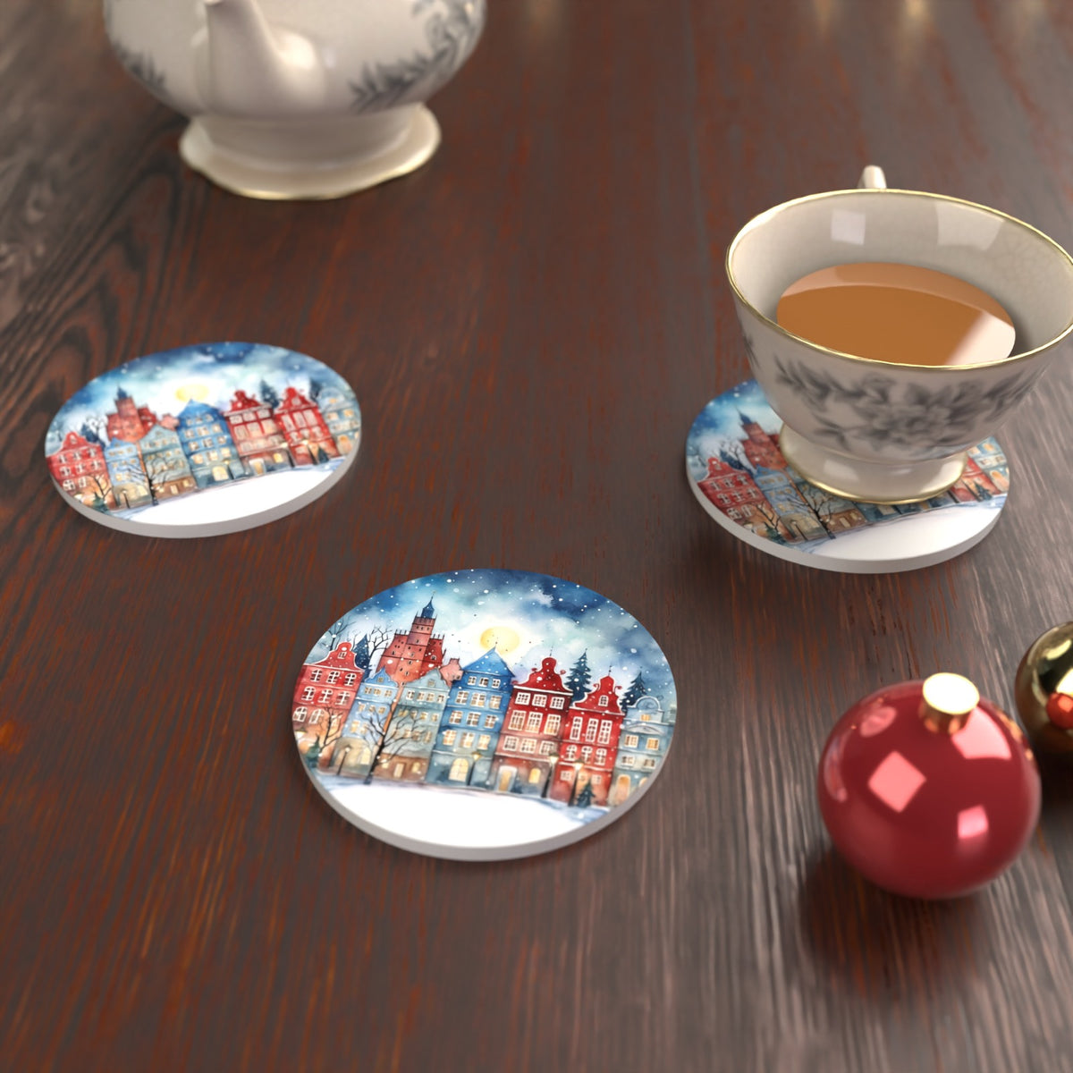 Watercolour Christmas Town Round Ceramic Coasters – Set of 6 – lifestyle mockup with a teacup
