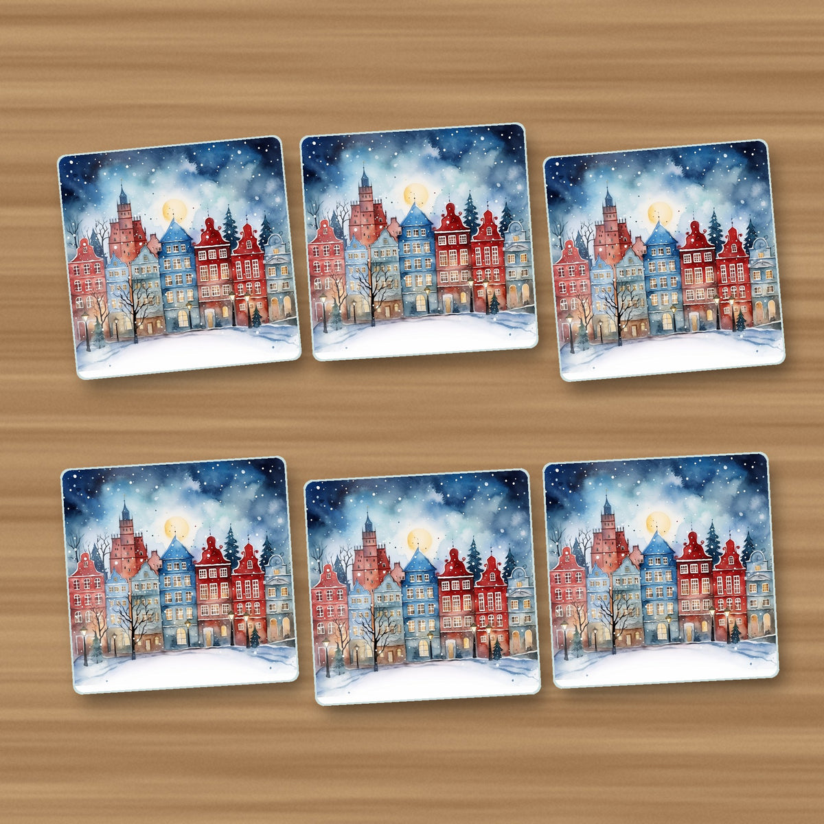 Watercolour Christmas Town square glass coasters, set of 6, on an oak coffee table