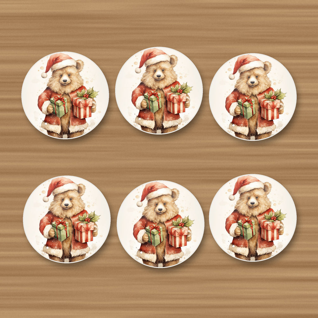 Christmas Teddy with Gifts round ceramic coasters, set of 6, on an oak coffee table