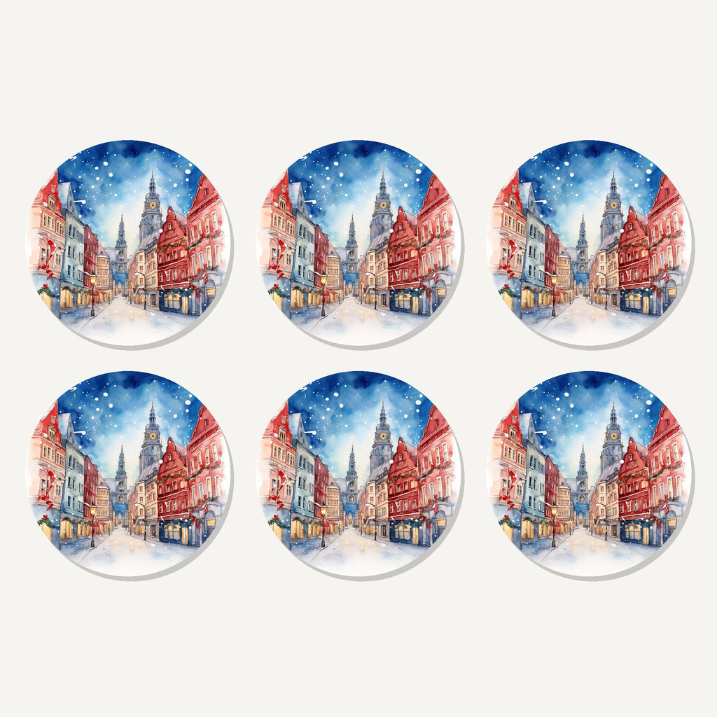 Flat lay of the snowy christmas street watercolour artwork on six round coasters