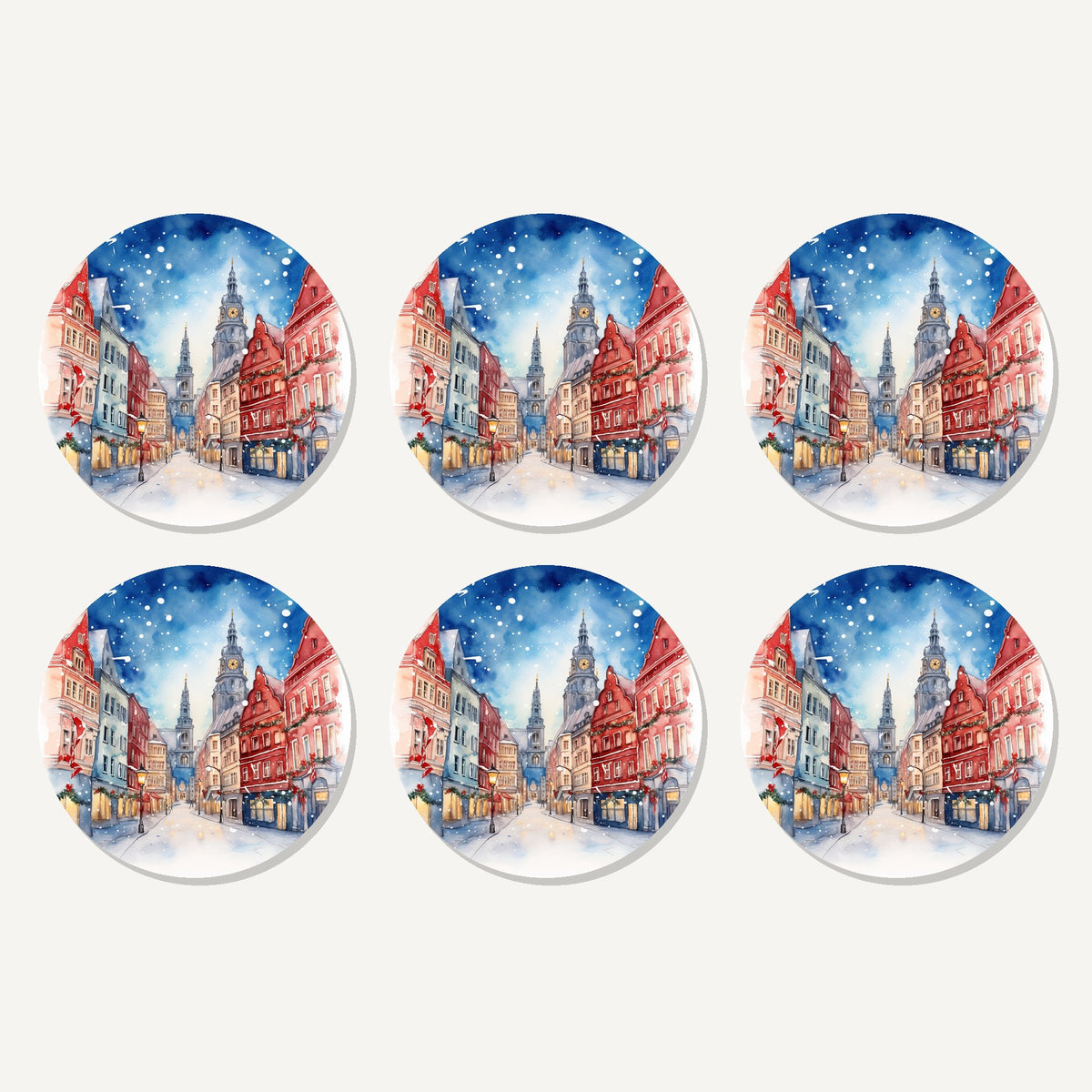 Flat lay of the snowy christmas street watercolour artwork on six round coasters