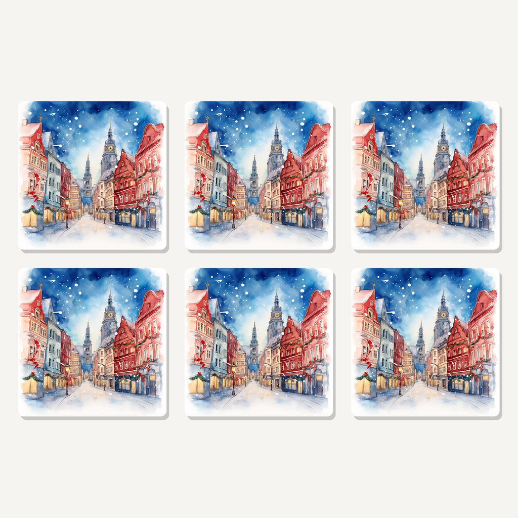Flat lay of the snowy christmas street watercolour artwork on six square coasters
