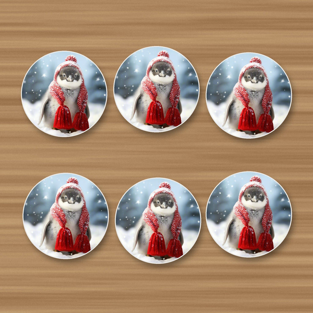 Penguin Chick in Red Knitted Hat round ceramic coasters, set of 6, on an oak coffee table