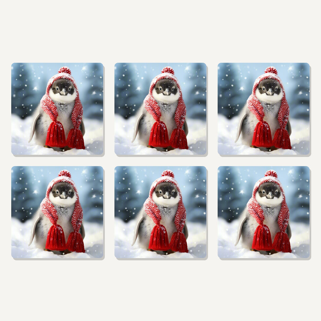 Flat lay of the penguin chick in red knitted hat artwork on six square coasters