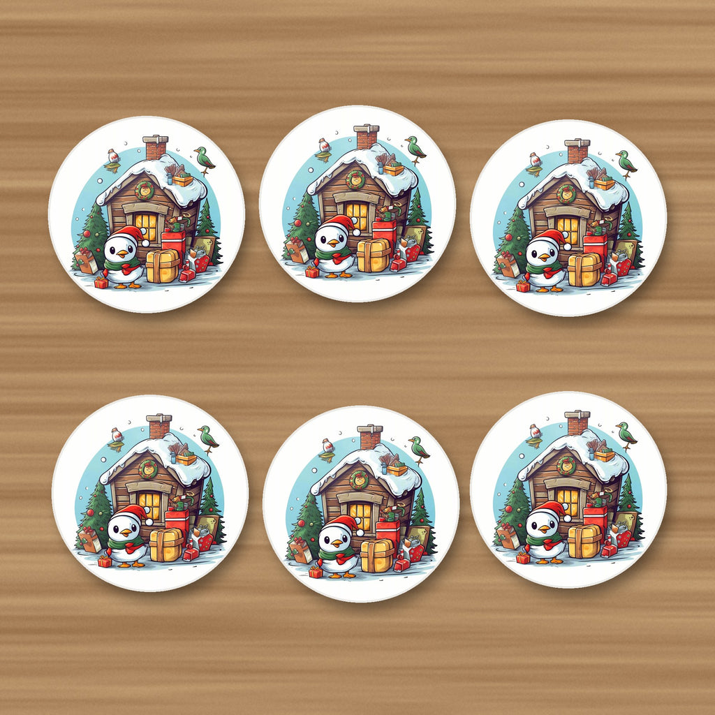 Christmas Cabin with Penguin round ceramic coasters, set of 6, on an oak coffee table