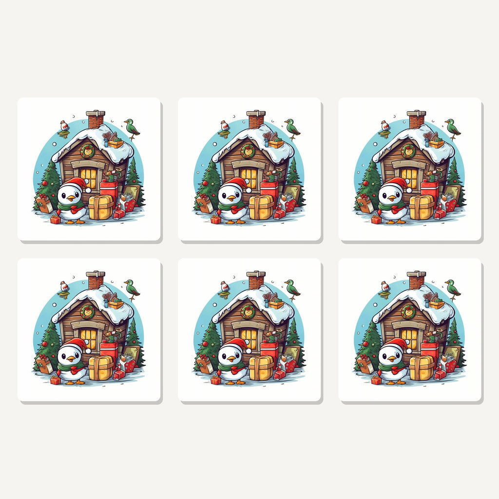 Flat lay of the christmas cabin with penguin artwork on six square coasters