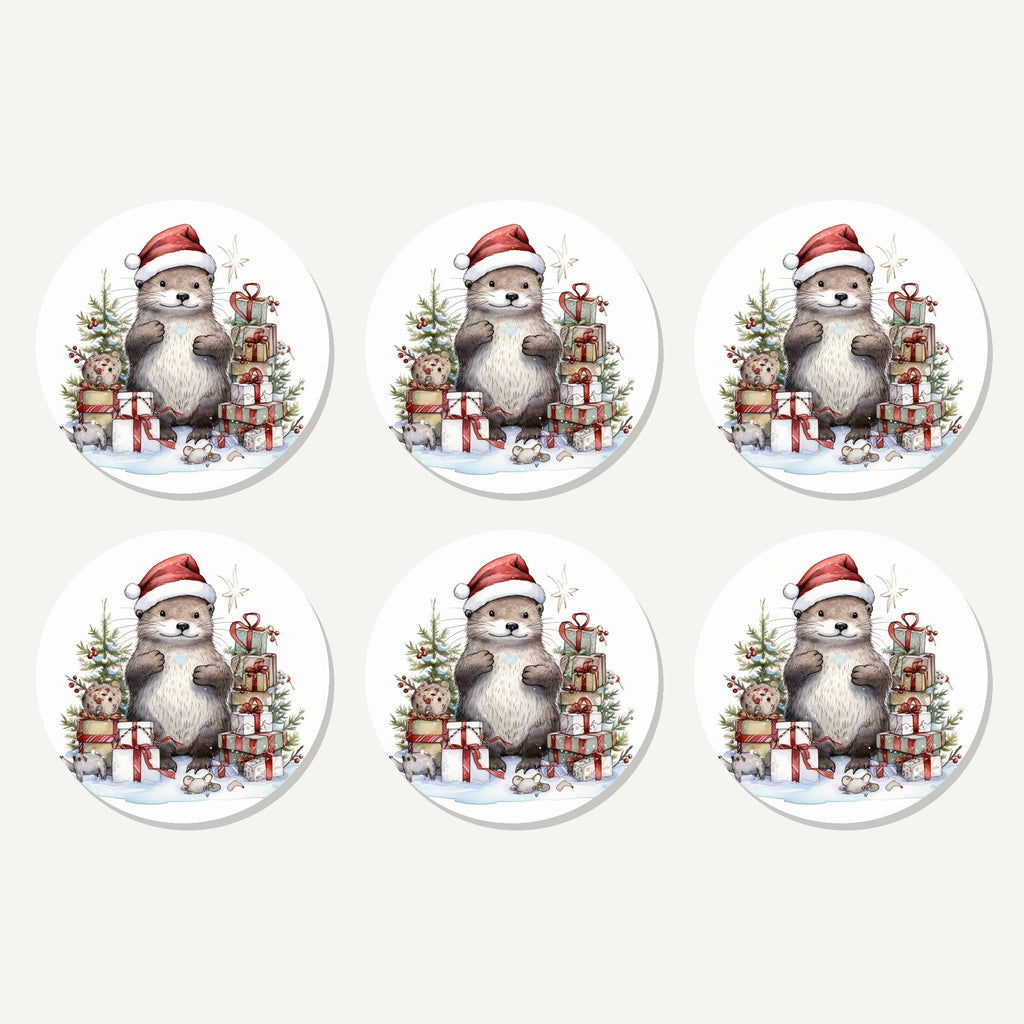 Flat lay of the christmas otter with gifts artwork on six round coasters