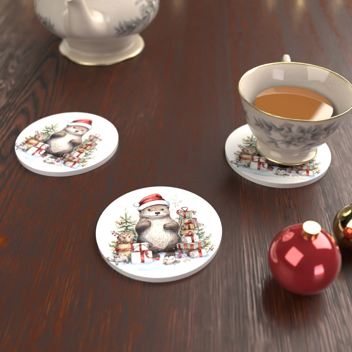 Christmas Otter with Gifts Round Ceramic Coasters – Set of 6 – lifestyle mockup with a teacup