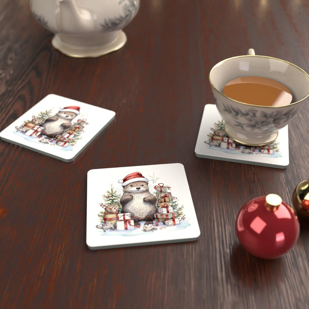 Christmas Otter with Gifts Square Glass Coasters – Set of 6 – lifestyle mockup with a teacup