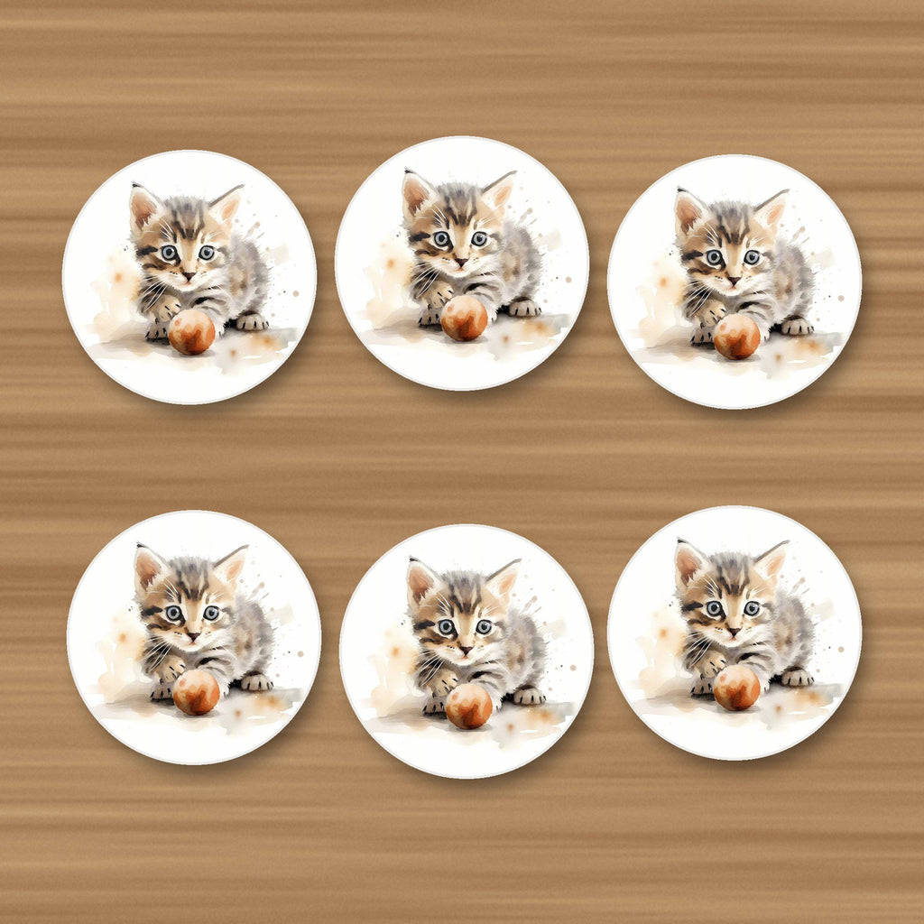 Tabby Kitten with Ball round ceramic coasters, set of 6, on an oak coffee table