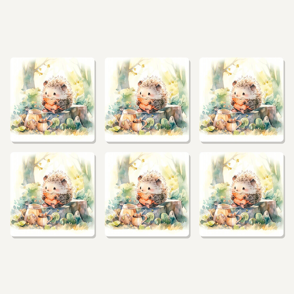Flat lay of the watercolour woodland hedgehog artwork on six square coasters