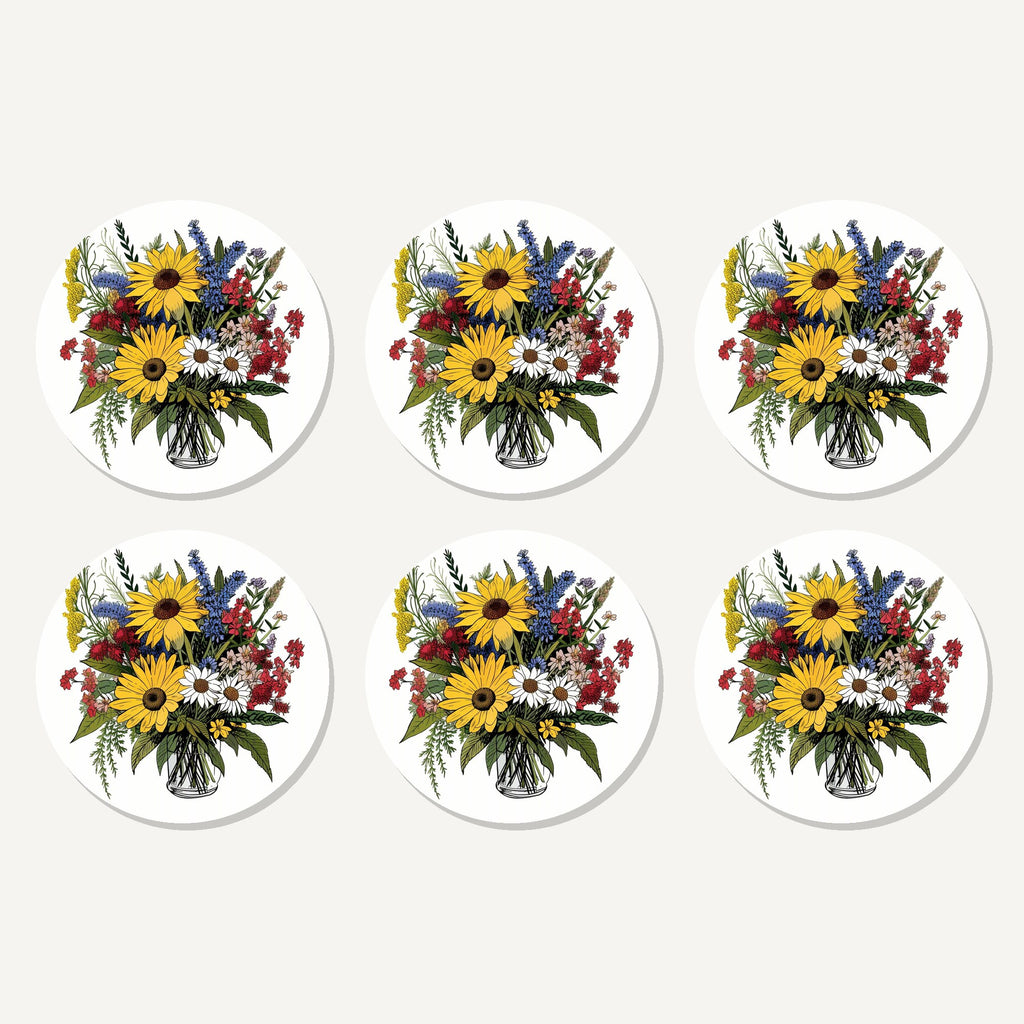 Flat lay of the sunflower & wildflower bouquet artwork on six round coasters