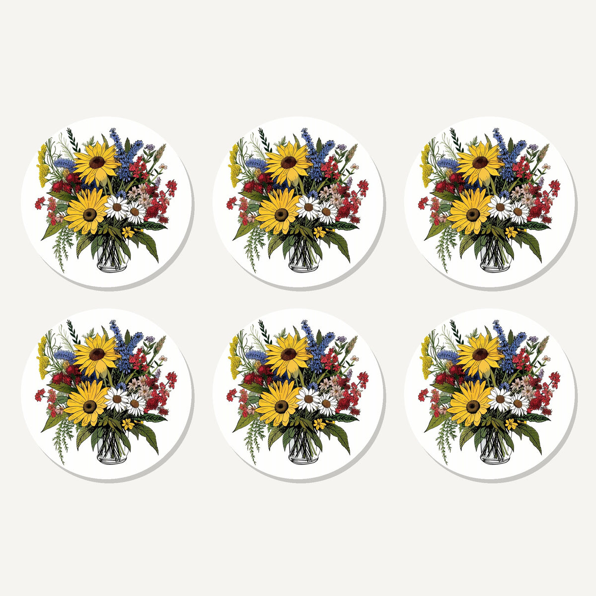 Flat lay of the sunflower & wildflower bouquet artwork on six round coasters