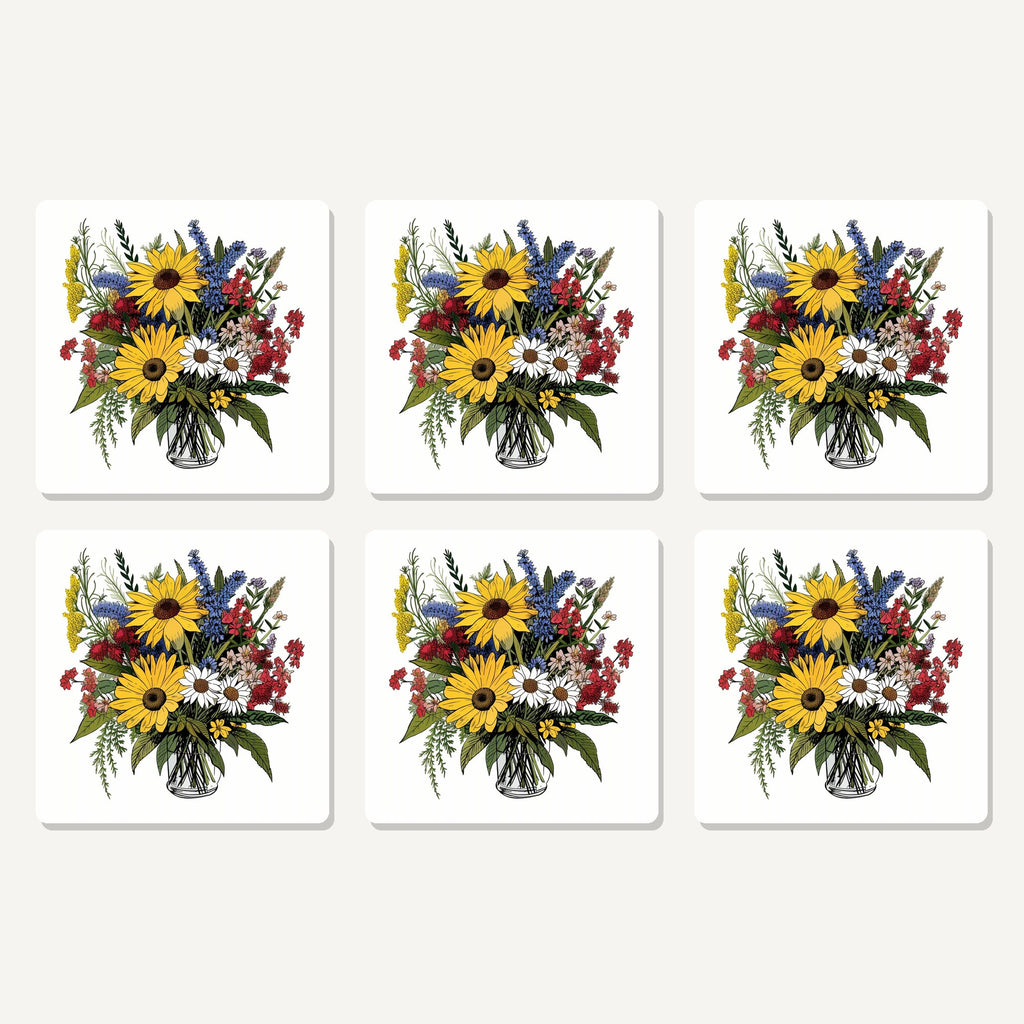 Flat lay of the sunflower & wildflower bouquet artwork on six square coasters