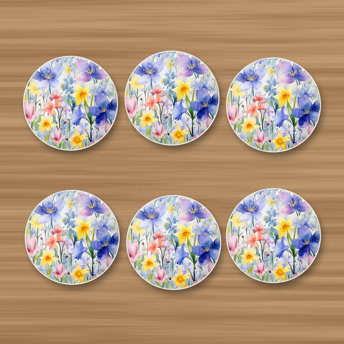 Watercolour Spring Flowers round ceramic coasters, set of 6, on an oak coffee table