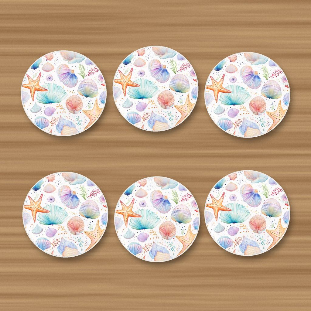Watercolour Seashells & Starfish round ceramic coasters, set of 6, on an oak coffee table