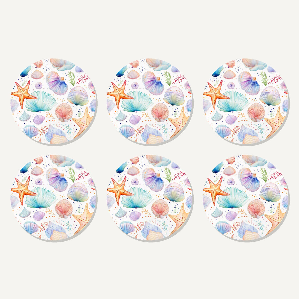 Flat lay of the watercolour seashells & starfish artwork on six round coasters