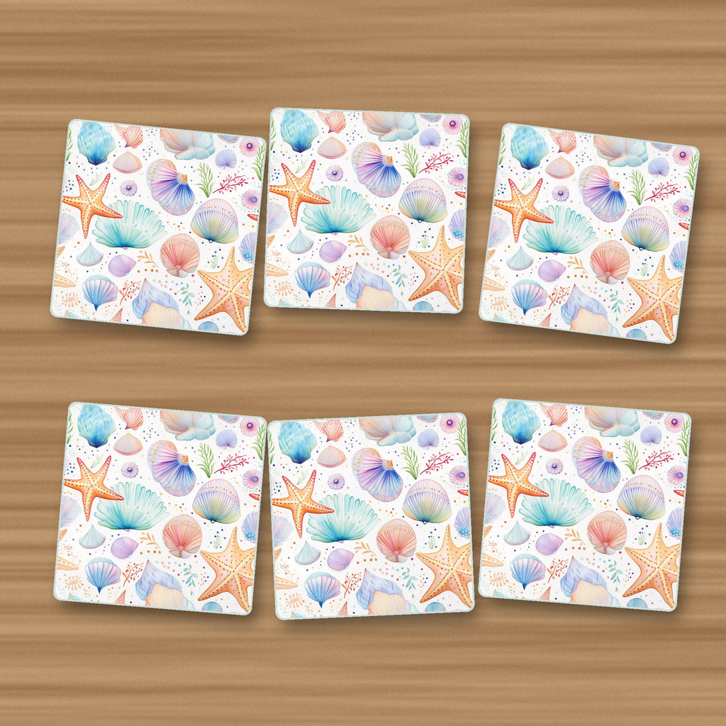 Watercolour Seashells & Starfish square glass coasters, set of 6, on an oak coffee table