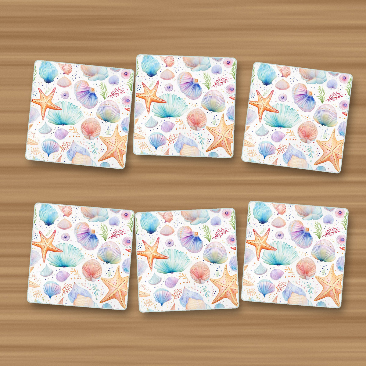 Watercolour Seashells & Starfish square glass coasters, set of 6, on an oak coffee table