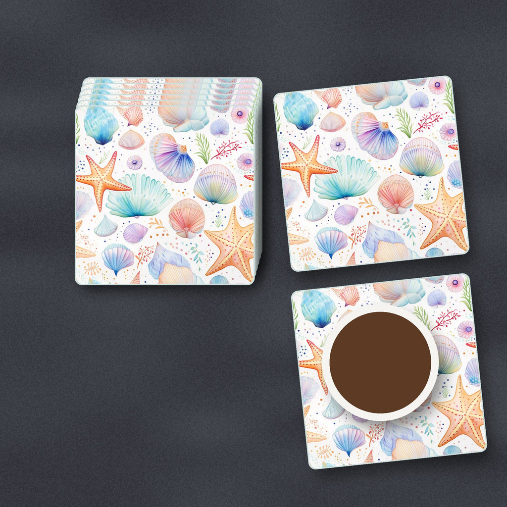 Watercolour Seashells & Starfish square glass coasters stacked on a slate kitchen worktop