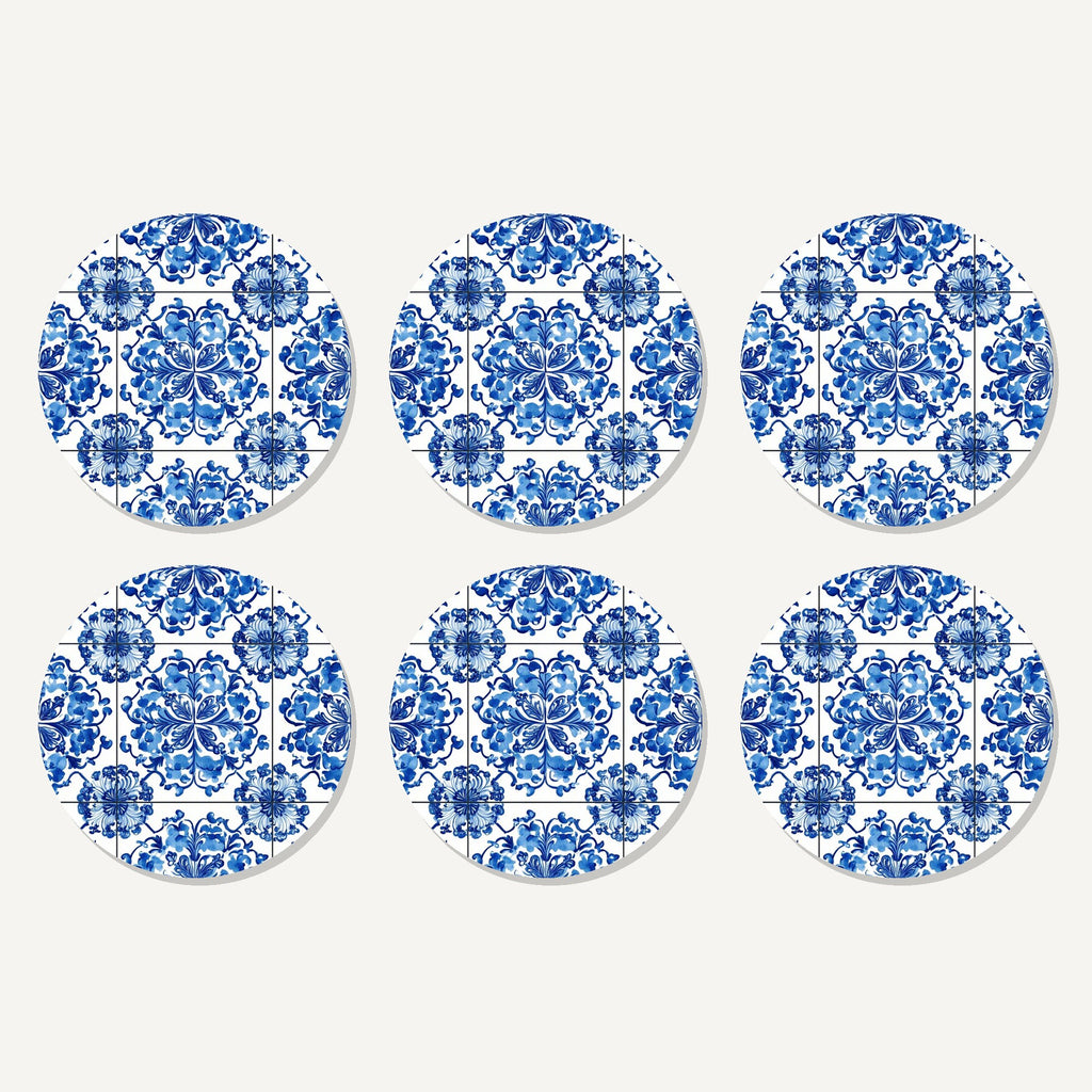 Flat lay of the blue & white floral tile artwork on six round coasters
