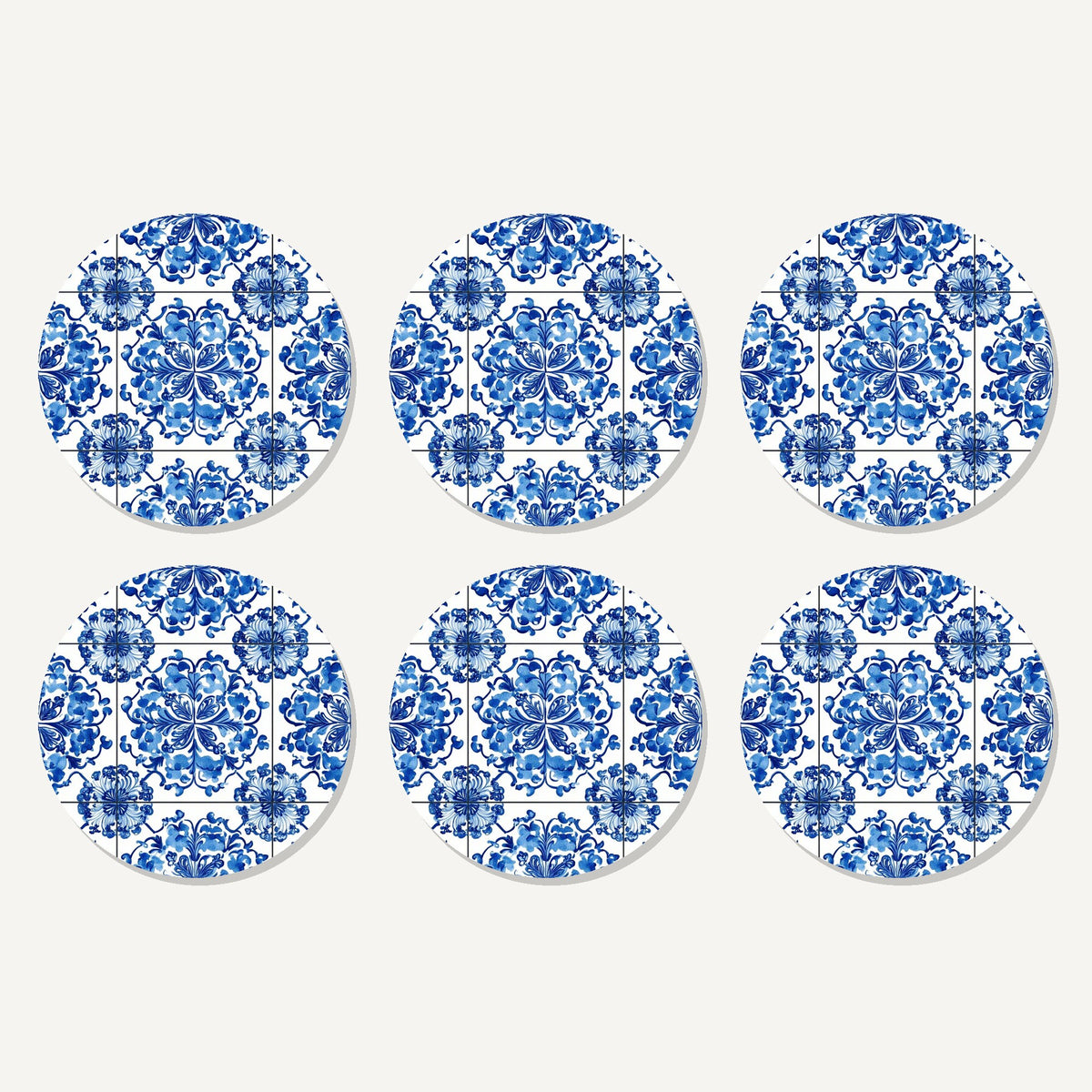 Flat lay of the blue & white floral tile artwork on six round coasters
