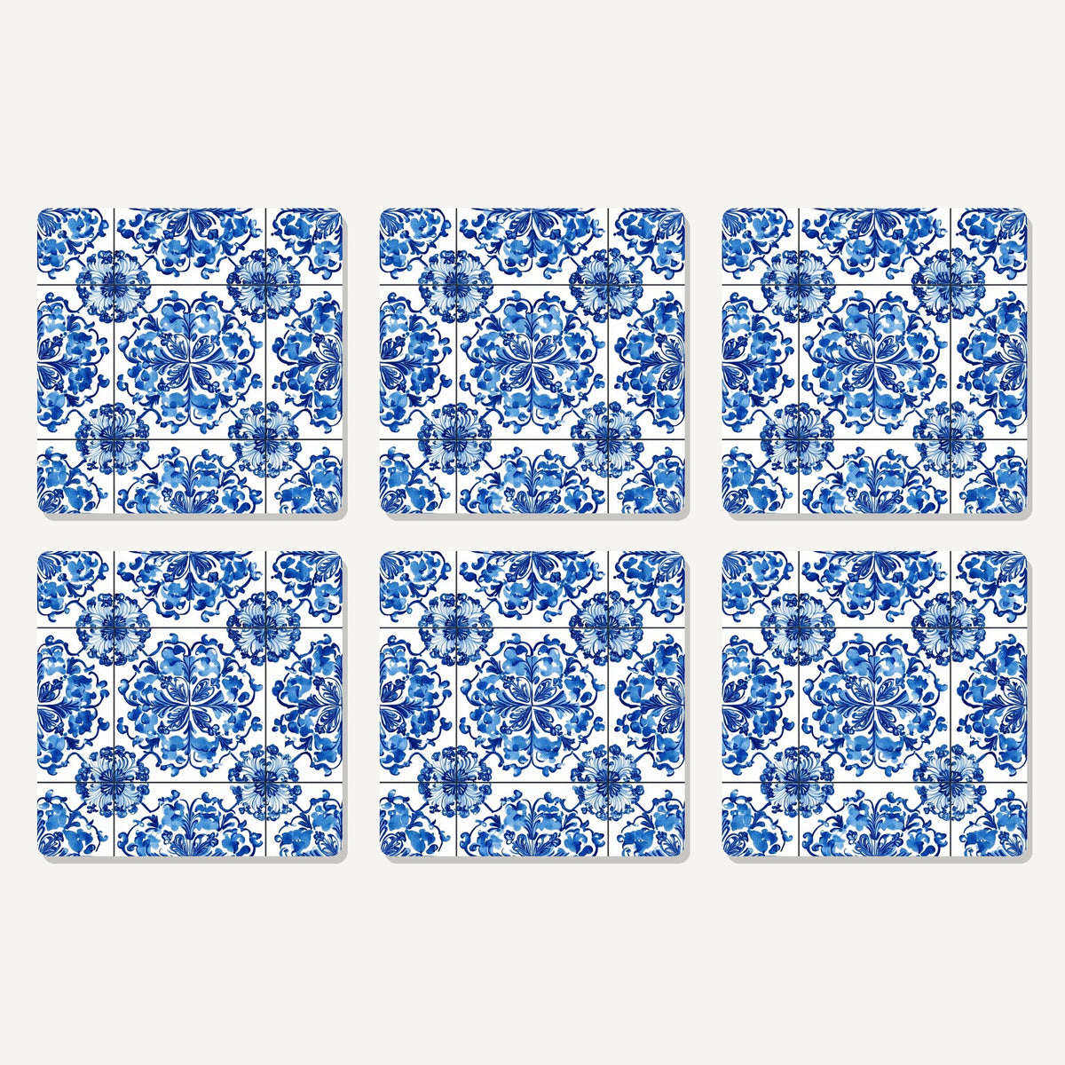 Flat lay of the blue & white floral tile artwork on six square coasters