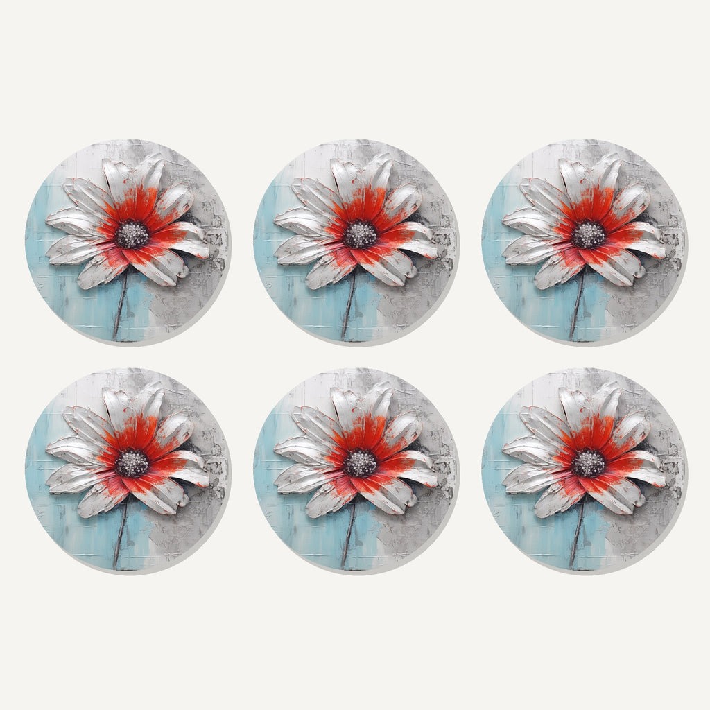 Flat lay of the white & red flower on pale blue artwork on six round coasters