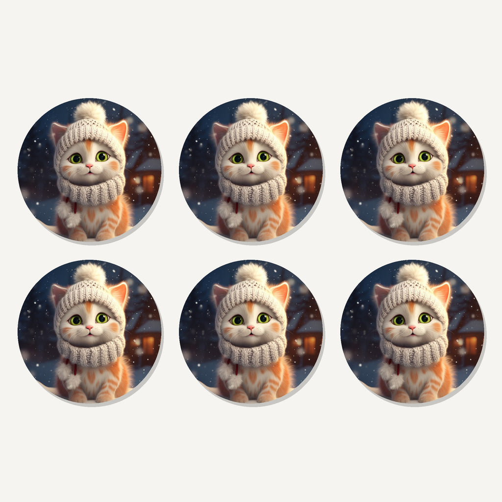 Flat lay of the kitten in a knitted bobble hat artwork on six round coasters