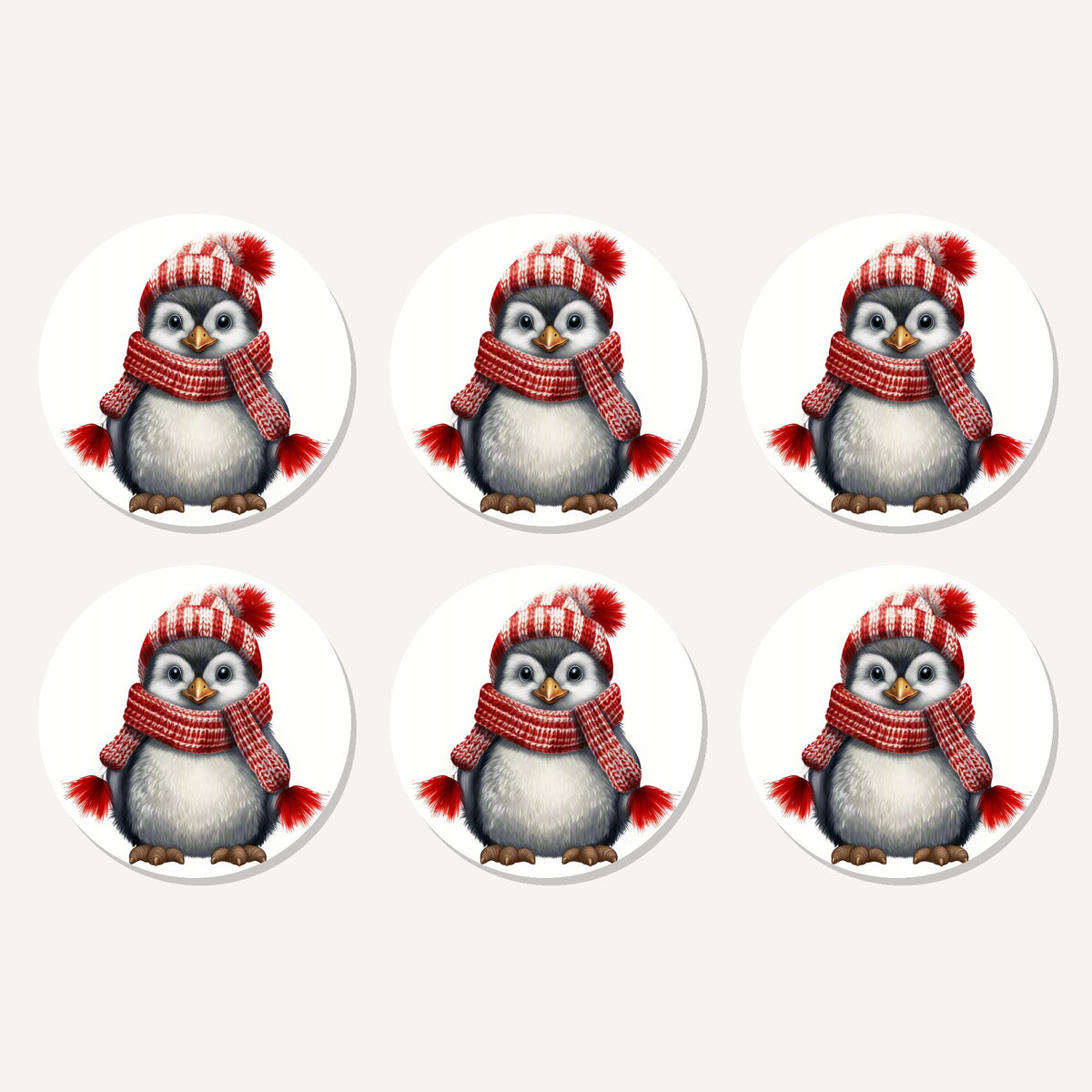 Flat lay of the penguin in a red bobble hat artwork on six round coasters