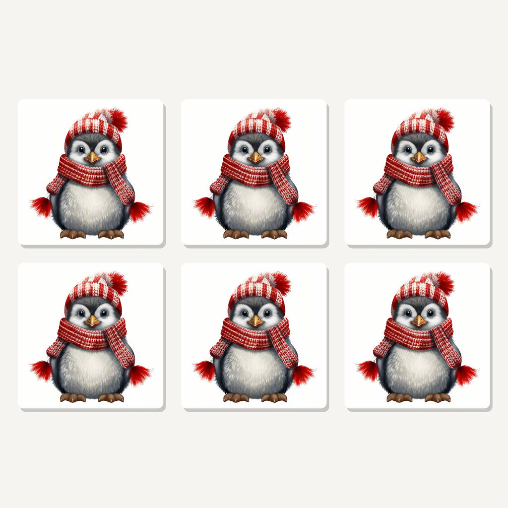 Flat lay of the penguin in a red bobble hat artwork on six square coasters