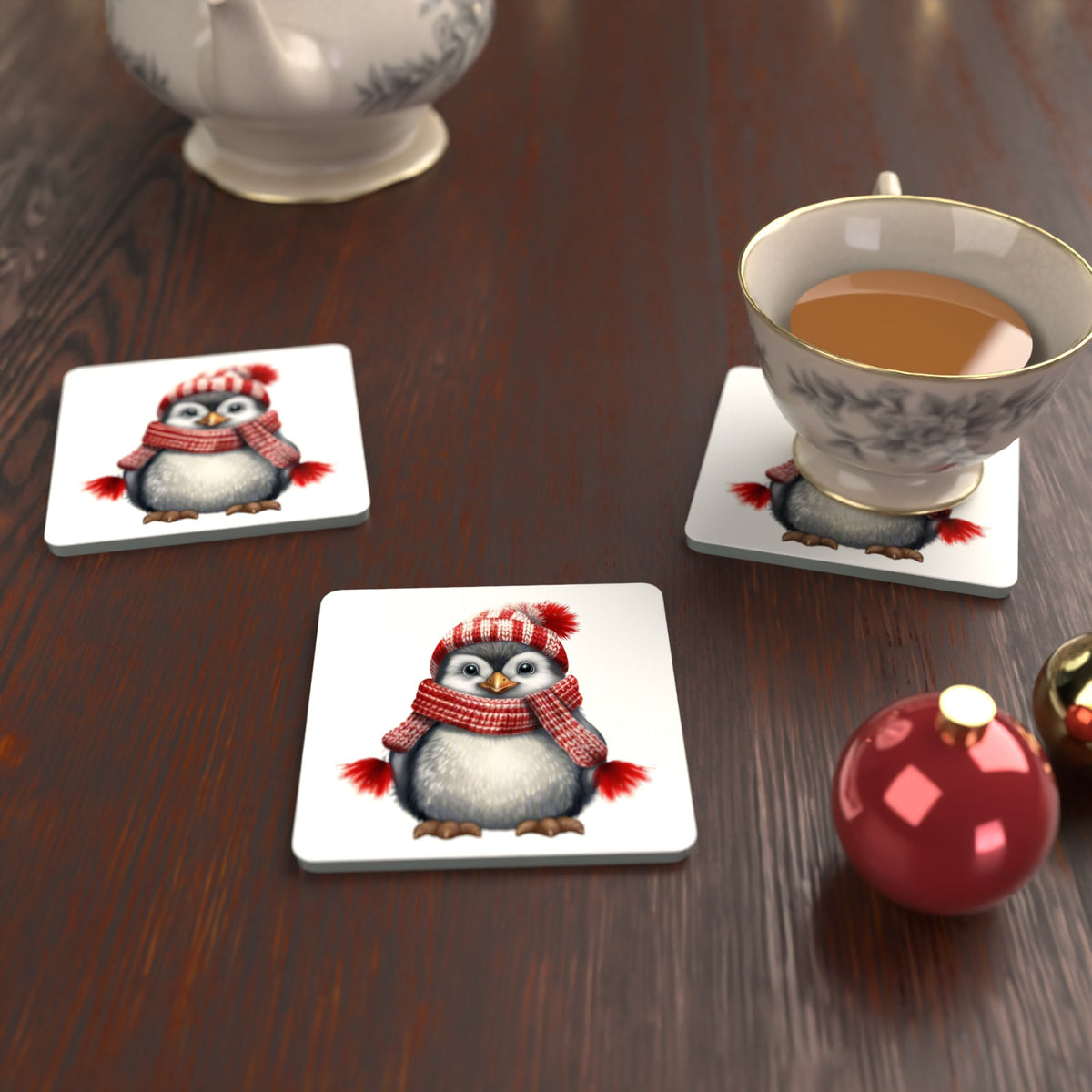 Penguin in a Red Bobble Hat Square Glass Coasters – Set of 6 – lifestyle mockup with a teacup