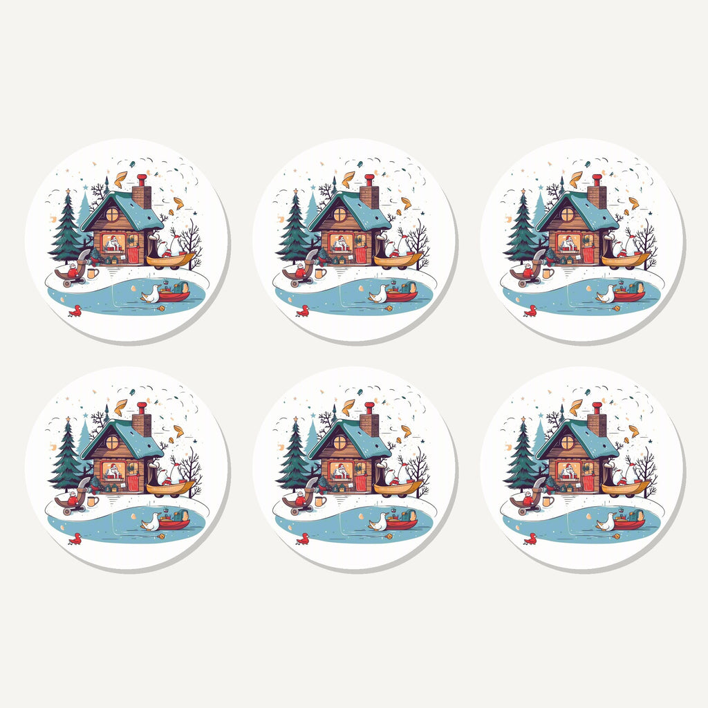 Flat lay of the christmas cottage & frozen pond artwork on six round coasters