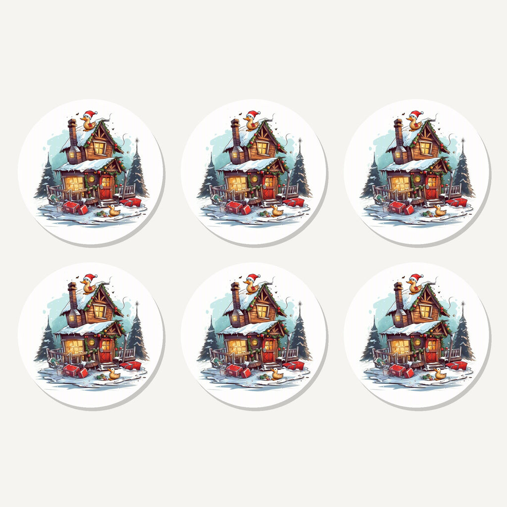 Flat lay of the snowy log cabin with ducks artwork on six round coasters