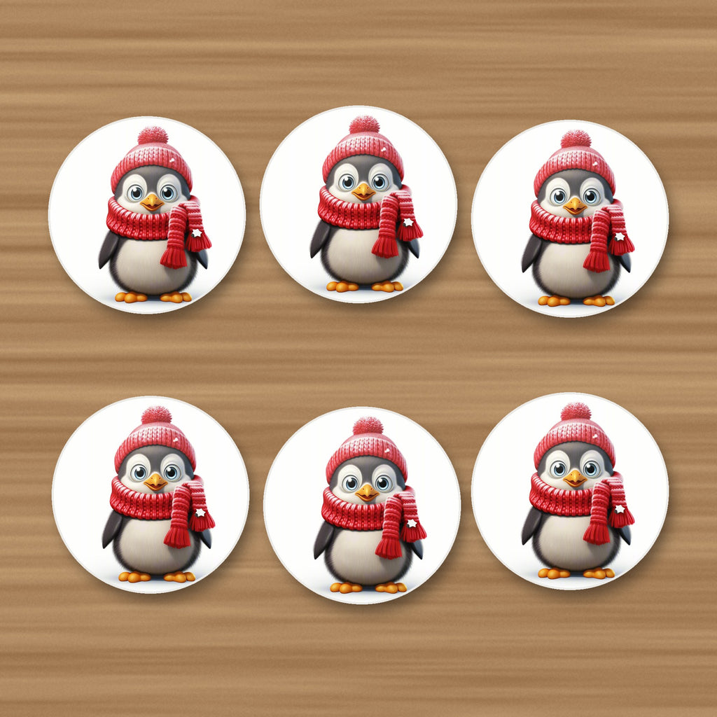 Cheerful Penguin in Red Hat & Scarf round ceramic coasters, set of 6, on an oak coffee table