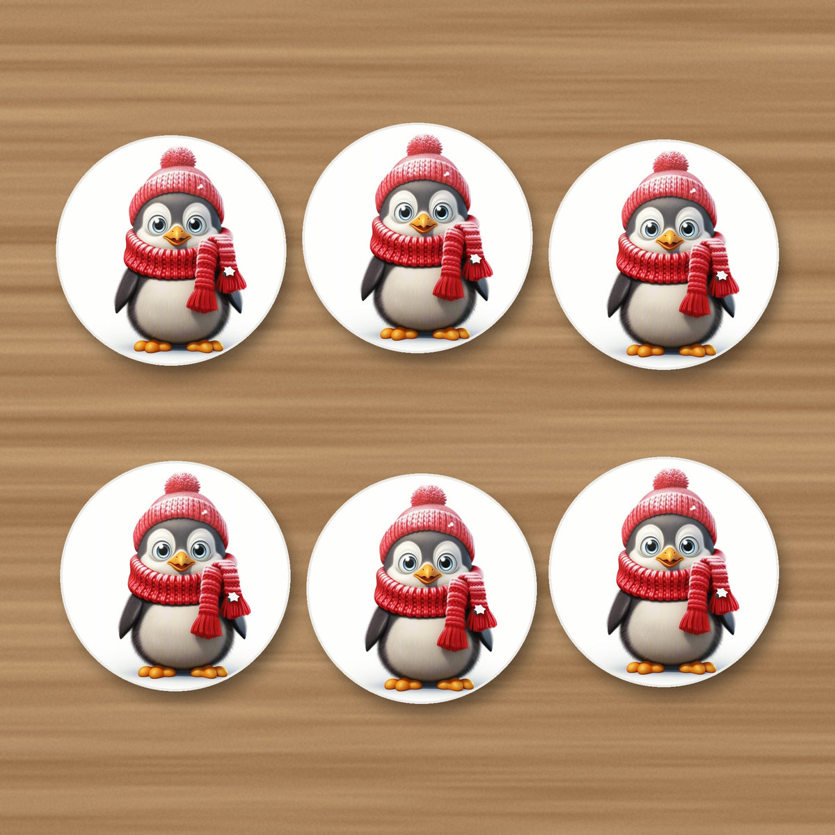 Cheerful Penguin in Red Hat & Scarf round ceramic coasters, set of 6, on an oak coffee table