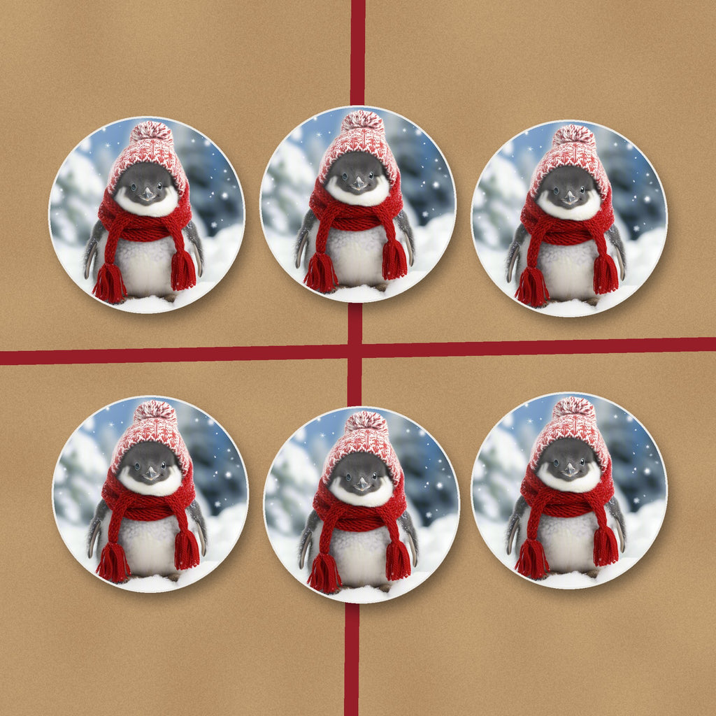 Penguin Chick in the Snow round ceramic coasters on kraft gift wrap