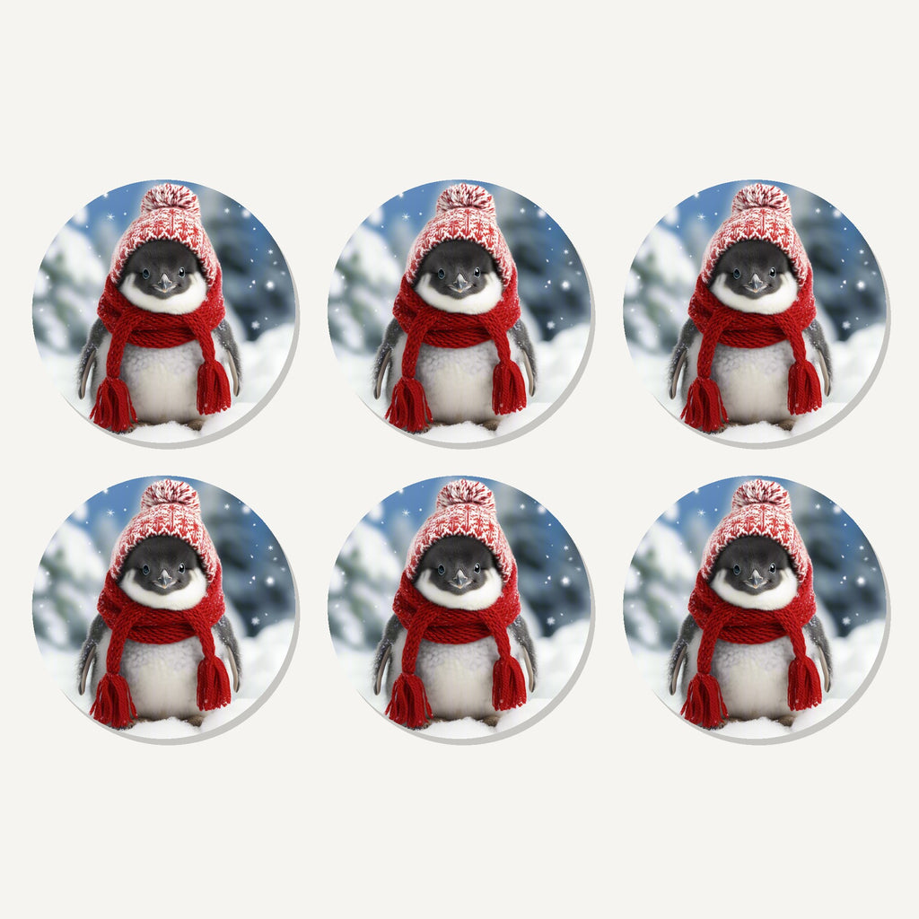 Flat lay of the penguin chick in the snow artwork on six round coasters