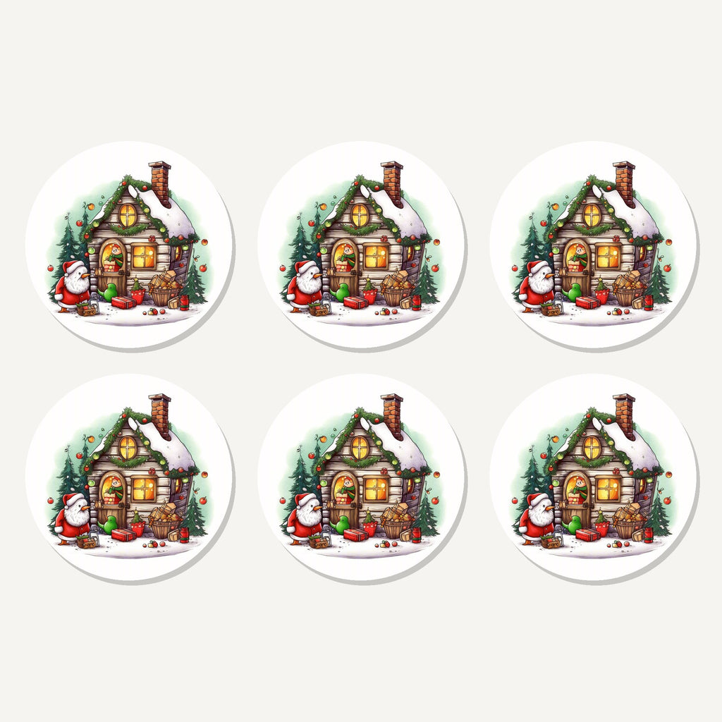 Flat lay of the christmas cottage with father christmas artwork on six round coasters