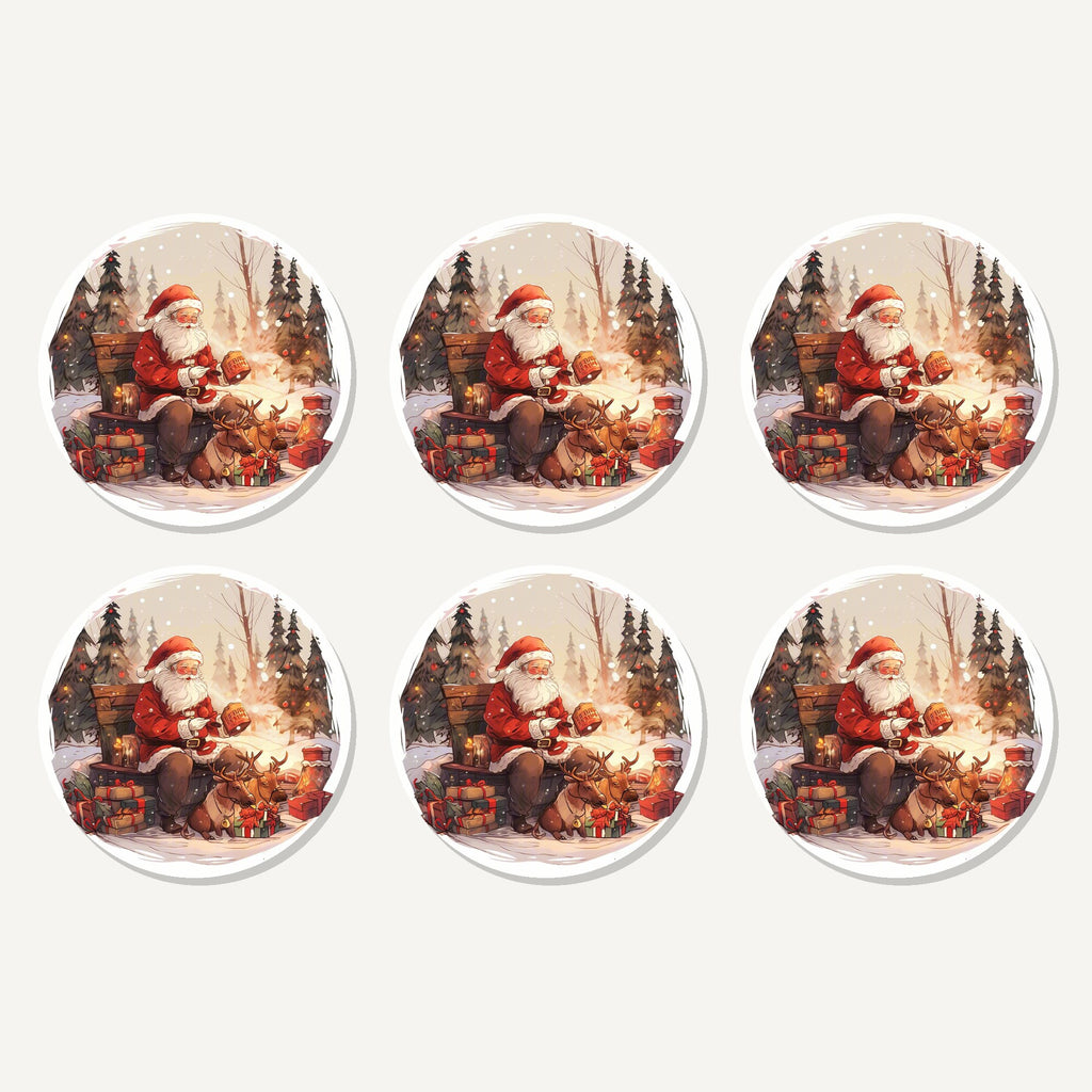 Flat lay of the father christmas & reindeer in the woods artwork on six round coasters