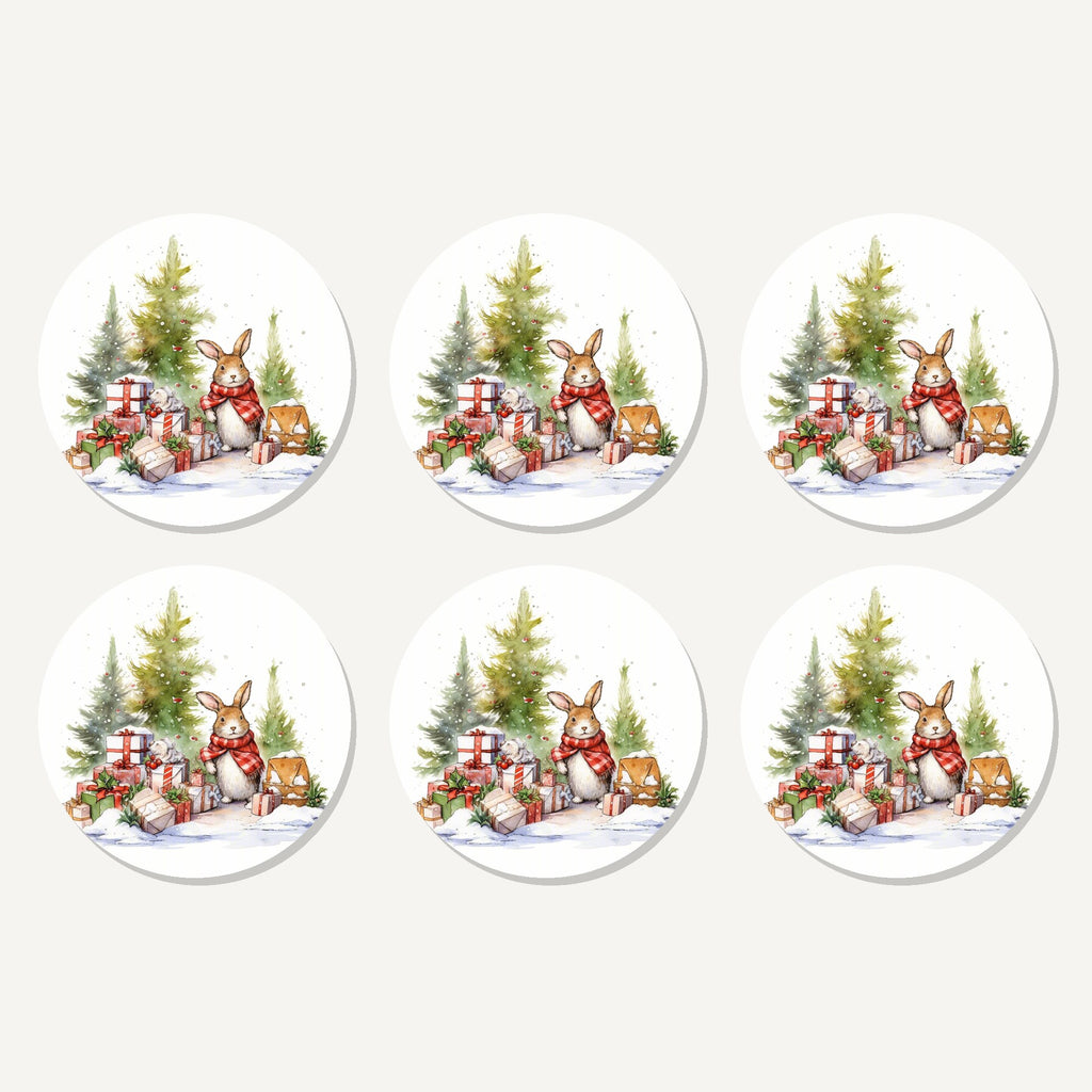 Flat lay of the christmas rabbit with presents artwork on six round coasters