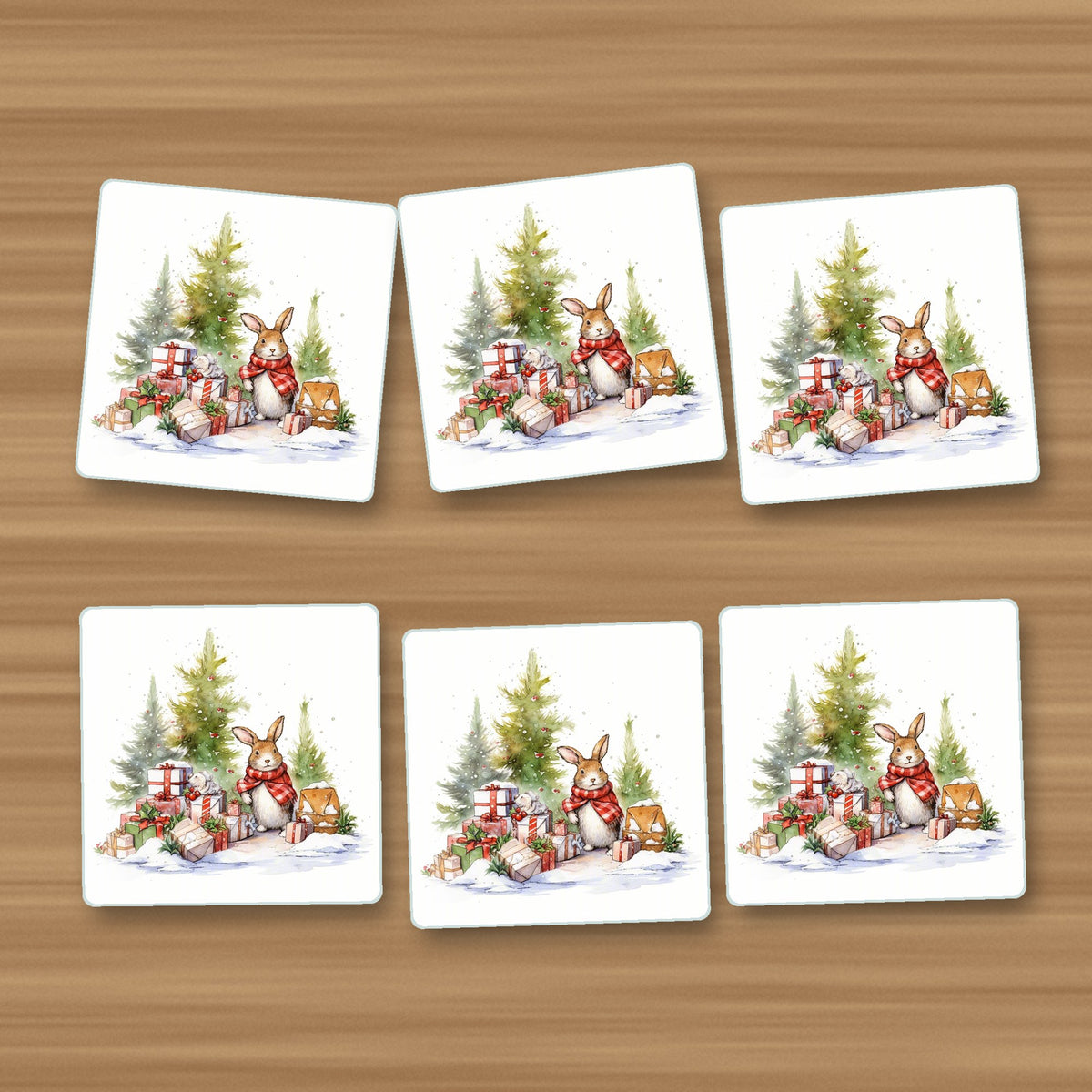 Christmas Rabbit with Presents square glass coasters, set of 6, on an oak coffee table