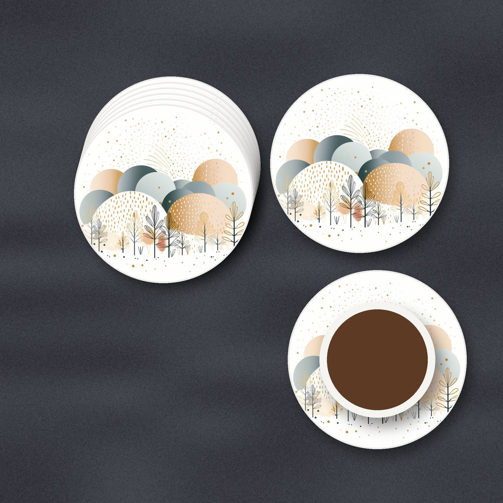 Minimalist Gold Winter Trees round ceramic coasters stacked on a slate kitchen worktop